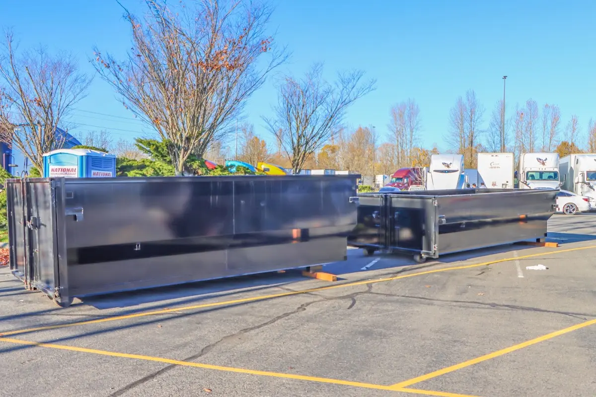 Professional dumpster rental service with roll-off container on residential driveway in Kennewick